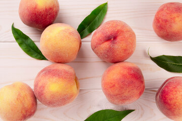 Fresh peaches on a wooden table.