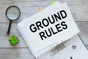 GROUND RULES text on white paper on a folder with documents