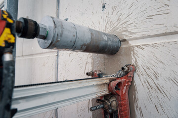 Drilling a hole into a concrete floor with core driller