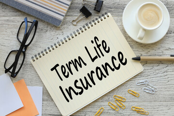 Term life insurance notepad with text. a cup of coffee