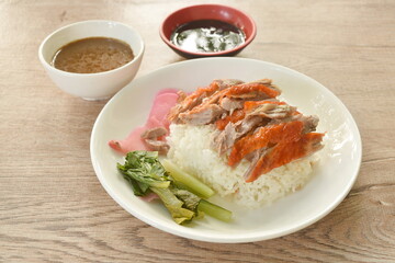 slice roasted duck topping rice with pink pickled ginger and boiled cabbage dressing sweet soy sauce on plate