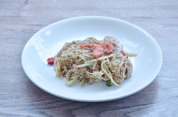 chop unripe mango with dry shrimp and chili Thai salad on plate