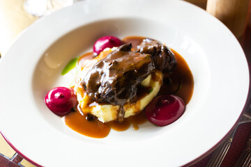 Beef cheek with mashed potatoes and currant oil