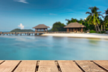 Fototapeta premium wooden table for display product, tables of wood for showing goods, empy surface, tropical beach landscape on the background