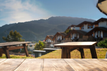 Naklejka premium wooden table for display product, tables of wood for showing goods, empy surface, mountains landscape on the background