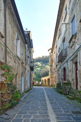 A narrow street between the old houses of Perdifumo, a village in Campania in Italy.