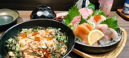 Healthy sushi meal with salmon and shrimp on a white plate