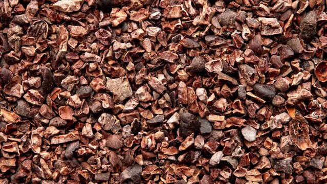 Background of Organic Cacao Nibs Top View. Cacao Nibs Texture. Raw Vegan Chocolate Concept.