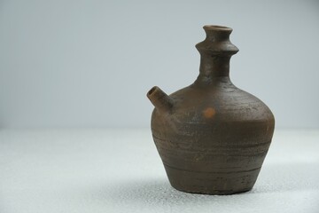 Isolated Kendi on a white background, kendi is the name of a traditional Javanese Indonesian drinking pot made of clay.