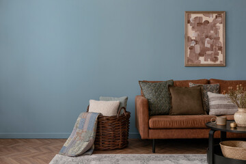 Stylish composition of rural style living room interior with brown sofa, pouf, mock up poster...