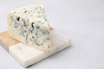 Tasty blue cheese on light table. Space for text
