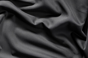 Fototapeta premium black silk background, satin texture, waving textile