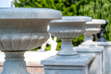 Stone vases on a pedestal in the park.