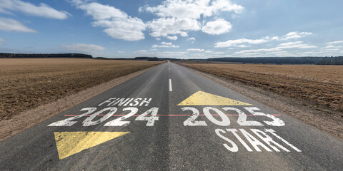numbers 2024 2025 start and finish on asphalt road highway with sky background. concept of...