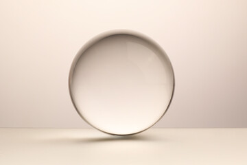 Transparent glass ball on light grey background