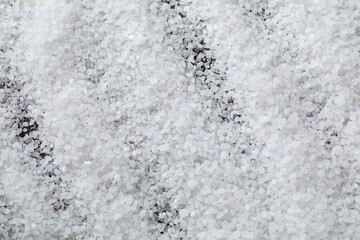 White natural salt as background, top view