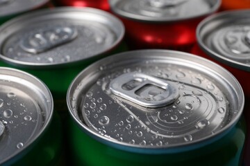 Energy drinks in wet cans, closeup. Functional beverage