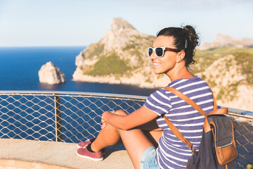 Smiling woman enjoying scenic coastal view