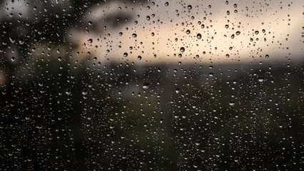 Foto op Plexiglas Raindrops on the glass close-up, rainy day, blurred background © Rostislav