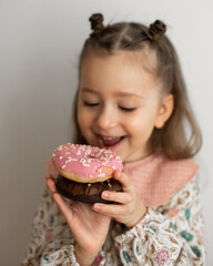 little girl eating  donut