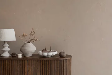 Fototapete Japandi Minimalist composition of stylish living room interior with wooden commode, design paper table lamp, dried flowers in vase, decoration and personal accessories. Template. Home decor. Copy space.  © FollowTheFlow