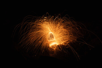 Abstract background of steel wool fireworks on Hat Chom Dao at after twilight blue hour, Showers of...