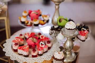 Almond cookies, sweet cakes for a wedding banquet. A delicious reception, a luxurious ceremony. Table with sweets and desserts. Delicious colorful French desserts on a plate or table. Candy bar.