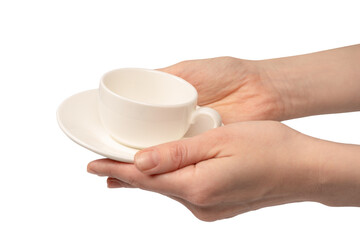 Female hand holding coffee cup and saucer isolated on white background.