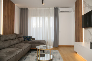 Naklejka na ściany i meble Modern,stylish and cozy living room with brown sofa and round coffee table