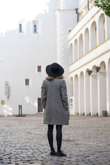 A girl in a hat got lost among the city streets