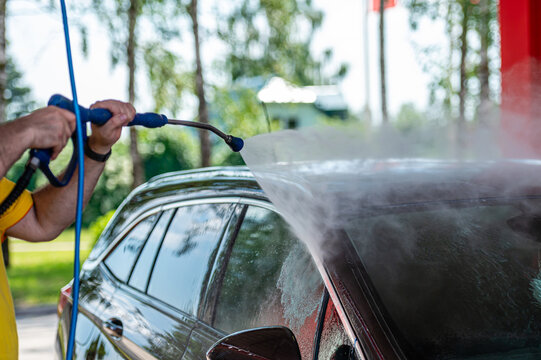 Closeup car washing with high pressure car washer spray gun © ako-photography