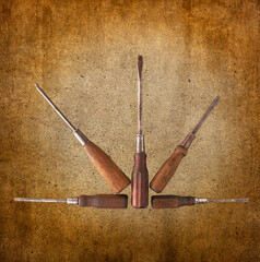 A fan-like array of five old phillips and straight blade wooden handle screw drivers showing the proud patina of many decades of use.