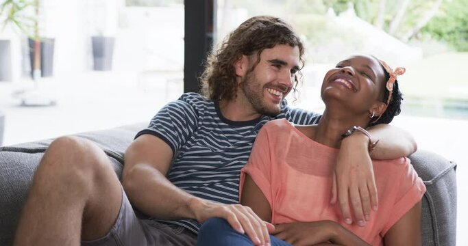 Diverse couple enjoys a cozy moment at home