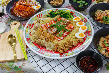 Delicious egg noodles with sliced pork and wonton in a big bowl