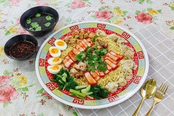 Delicious egg noodles with sliced pork and wonton in a big bowl