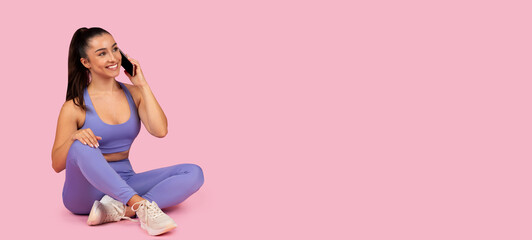 Relaxed woman talk on phone sitting in gym clothes, free space