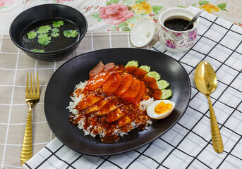 Rice with crispy and barbecued pork / Crispy and barbecued pork on rice.