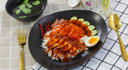 Rice with crispy and barbecued pork / Crispy and barbecued pork on rice.