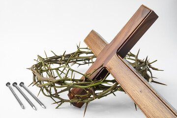 Jesus Wooden cross with nails and Crown of Thorns used by Catholic Christians on Good Friday Ceremony. Isolated on white background with empty blank copy text space. - obrazy, fototapety, plakaty