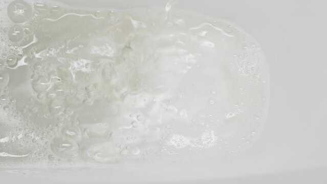 A stream of urine in a white toilet