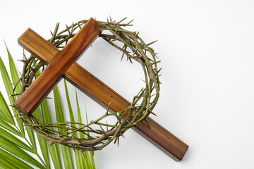 Illustration of Jesus Wooden cross with palm leaves and Crown of Thorns used by Catholic Christians...