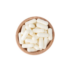 Fototapeta na wymiar Vitamin capsules in wooden bowl isolated on white, top view