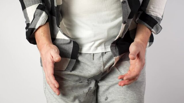 Man Pee His Pants, close-up.  A man suffering from pain in the pelvic organs