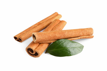 Cinnamon sticks and green leaf isolated on white