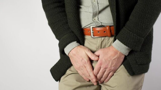 Man Pee His Pants, close-up.  A man suffering from pain in the pelvic organs
