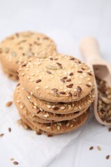 Cereal crackers with flax and sesame seeds on white table