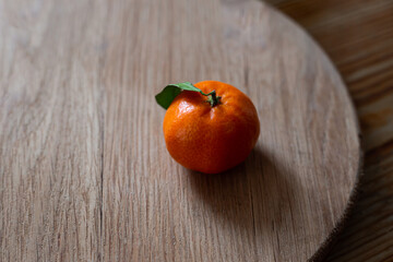 Mandarin or orange on white plate. Citrus clementine tangerine  served   on  wooden table.