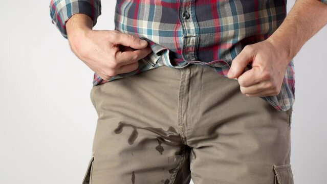 Man Pee His Pants, close-up.  A man suffering from pain in the pelvic organs