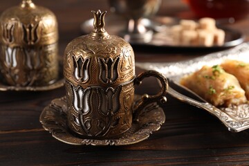 Traditional Turkish tea served in vintage tea set on wooden table