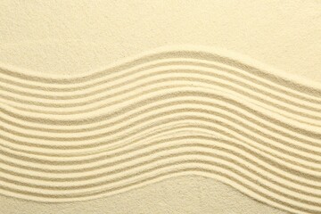 Zen rock garden. Wave pattern on beige sand, top view